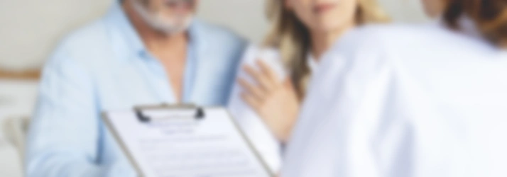 A softly blurred scene in a consultation setting