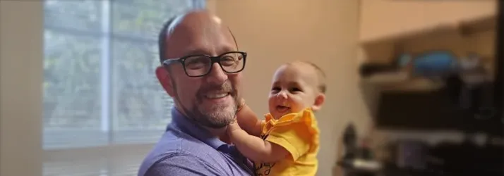 Dr. Steve Manuel holding baby